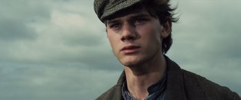 Movie still from “War Horse” (2011), directed by Steven Spielberg – A young man wearing a hat and a jacket; Close Up shot, Low angle