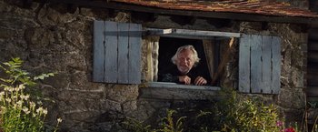 Movie still from “War Horse” (2011), directed by Steven Spielberg – An older man looking out of a window; Medium shot, Low angle