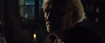 Movie still from “War Horse” (2011), directed by Steven Spielberg – An old man with a beard is looking into the distance; Close Up shot, Over the shoulder angle