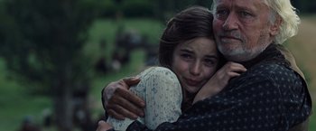 Movie still from “War Horse” (2011), directed by Steven Spielberg – An older man hugging a young girl in a field; Close Up shot, Over the shoulder angle