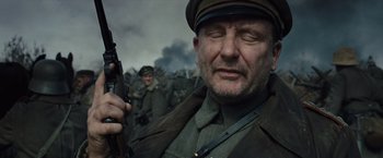 Movie still from “War Horse” (2011), directed by Steven Spielberg – An old man in uniform holding a rifle in front of a crowd of soldiers; Close Up shot, Low angle