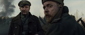 Movie still from “War Horse” (2011), directed by Steven Spielberg – Two men in military uniforms are looking at the camera; Medium shot, Low angle