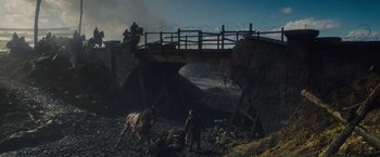 Movie still from “War Horse” (2011), directed by Steven Spielberg – A man on a horse near a bridge with barbed wire on it; Extreme Wide shot, High angle