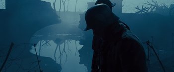 Movie still from “War Horse” (2011), directed by Steven Spielberg – Two men are standing near a body of water; Medium shot, Low angle