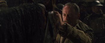 Movie still from “War Horse” (2011), directed by Steven Spielberg – A man holding a knife in his hand while standing next to a horse; Close Up shot, Low angle