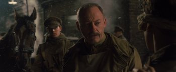 Movie still from “War Horse” (2011), directed by Steven Spielberg – An older man with a mustache; Close Up shot, Low angle