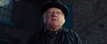 Movie still from “War Horse” (2011), directed by Steven Spielberg – An older man wearing a hat and a black coat; Close Up shot, Low angle