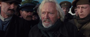 Movie still from “War Horse” (2011), directed by Steven Spielberg – An older man with a beard and a scarf; Close Up shot, Low angle