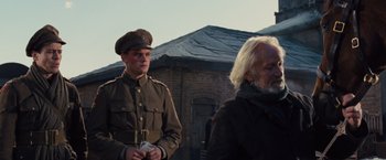 Movie still from “War Horse” (2011), directed by Steven Spielberg – A man in a military uniform standing next to another man; Medium shot, Low angle