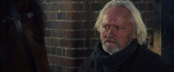 Movie still from “War Horse” (2011), directed by Steven Spielberg – An older man with a beard and a scarf; Close Up shot, Over the shoulder angle