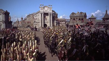 Movie still from “War and Peace” (1956), directed by King Vidor – A large crowd of people are marching down a street; Extreme Wide shot, High angle