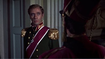Movie still from “War and Peace” (1956), directed by King Vidor – A man in a uniform looking at himself in the mirror; Medium shot, Over the shoulder angle