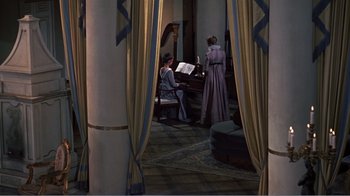 Movie still from “War and Peace” (1956), directed by King Vidor – Two women are dressed in period clothing and playing a piano; Wide shot, High angle