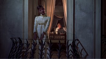 Movie still from “War and Peace” (1956), directed by King Vidor – A woman standing next to a person in a room; Wide shot, Low angle