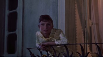 Movie still from “War and Peace” (1956), directed by King Vidor – A woman leaning on a railing in front of a window; Medium shot, Low angle