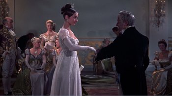 Movie still from “War and Peace” (1956), directed by King Vidor – A woman in a white dress and a man in a suit; Medium shot, Low angle