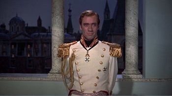 Movie still from “War and Peace” (1956), directed by King Vidor – A man dressed in a white uniform with gold medals on it; Medium shot, Low angle