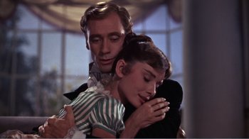 Movie still from “War and Peace” (1956), directed by King Vidor – A man and a woman embracing each other in front of a window; Close Up shot, Low angle