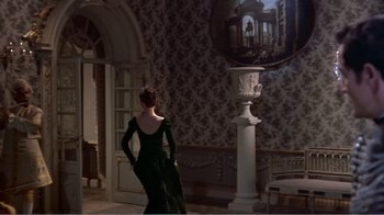 Movie still from “War and Peace” (1956), directed by King Vidor – A woman in a black dress standing next to a white vase; Wide shot, Over the shoulder angle