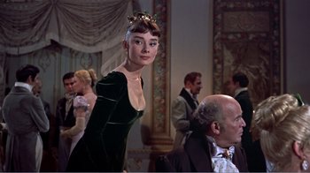 Movie still from “War and Peace” (1956), directed by King Vidor – A woman in a green dress and a man in a black suit; Medium shot, Over the shoulder angle