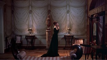 Movie still from “War and Peace” (1956), directed by King Vidor – A woman in a black dress talking on the phone; Wide shot, High angle