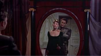 Movie still from “War and Peace” (1956), directed by King Vidor – A man and a woman in front of an oval mirror; Medium shot, Low angle