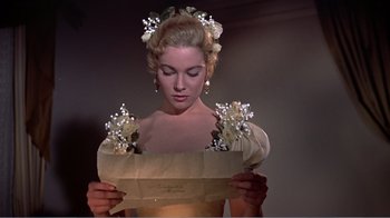 Movie still from “War and Peace” (1956), directed by King Vidor – A beautiful woman holding a paper bag with flowers on it; Close Up shot, Low angle