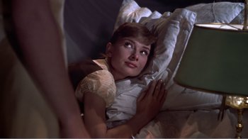 Movie still from “War and Peace” (1956), directed by King Vidor – A woman laying in a bed looking up at the sky; Medium shot, High angle