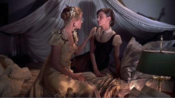 Movie still from “War and Peace” (1956), directed by King Vidor – Two beautiful women sitting on a bed talking; Medium shot, High angle
