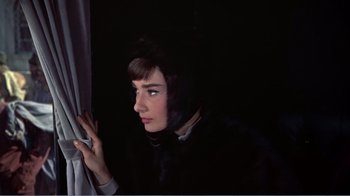Movie still from “War and Peace” (1956), directed by King Vidor – A woman looking out of a window at night; Close Up shot, High angle