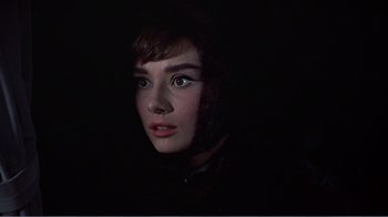 Movie still from “War and Peace” (1956), directed by King Vidor – A young woman with blue eye shadow is in the dark; Close Up shot, High angle