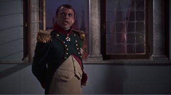 Movie still from “War and Peace” (1956), directed by King Vidor – A man dressed in a military uniform standing in front of a window; Medium shot, Low angle