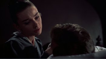 Movie still from “War and Peace” (1956), directed by King Vidor – A woman is looking down at a man's face; Close Up shot, Over the shoulder angle