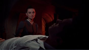 Movie still from “War and Peace” (1956), directed by King Vidor – A woman standing in front of a man in a bed; Medium shot, Low angle