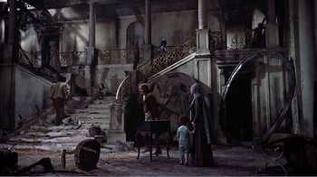 Movie still from “War and Peace” (1956), directed by King Vidor – A group of people standing in a room with stairs; Wide shot, High angle