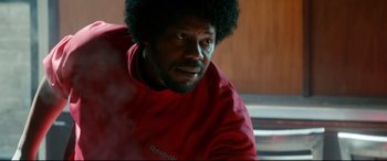 Movie still from “War on Everyone” (2016), directed by John Michael McDonagh – A person wearing a red jacket; Close Up shot, Low angle