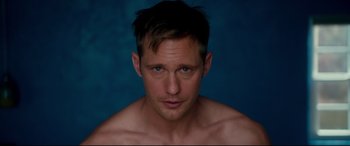 Movie still from “War on Everyone” (2016), directed by John Michael McDonagh – A person wearing a shirt; Close Up shot, High angle