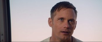 Movie still from “War on Everyone” (2016), directed by John Michael McDonagh – A man's face with a sky background; Close Up shot, Over the shoulder angle