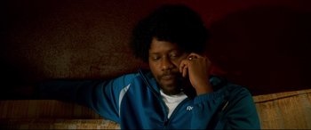 Movie still from “War on Everyone” (2016), directed by John Michael McDonagh – A man in a blue jacket is talking on a phone; Close Up shot, Low angle