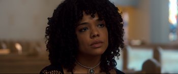 Movie still from “War on Everyone” (2016), directed by John Michael McDonagh – A person wearing a necklace; Close Up shot, Over the shoulder angle