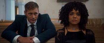 Movie still from “War on Everyone” (2016), directed by John Michael McDonagh – A man and a woman sitting next to each other; Close Up shot, Over the shoulder angle