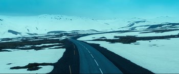Movie still from “War on Everyone” (2016), directed by John Michael McDonagh – An empty road in the middle of a snow covered field; Extreme Wide shot, High angle