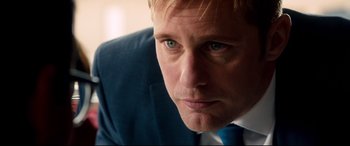 Movie still from “War on Everyone” (2016), directed by John Michael McDonagh – A person wearing a suit and tie; Close Up shot, Over the shoulder angle