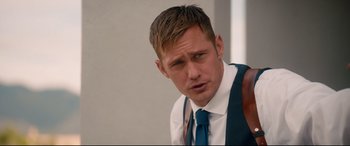Movie still from “War on Everyone” (2016), directed by John Michael McDonagh – A person wearing a suit and a tie; Close Up shot, Over the shoulder angle