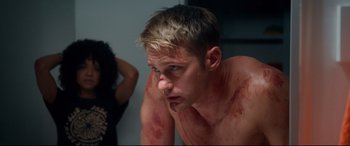 Movie still from “War on Everyone” (2016), directed by John Michael McDonagh – A man with blood all over his face and chest; Close Up shot, Over the shoulder angle