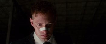 Movie still from “War on Everyone” (2016), directed by John Michael McDonagh – A man with a piece of paper taped to his face; Close Up shot, Low angle