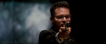 Movie still from “War on Everyone” (2016), directed by John Michael McDonagh – A man holding a gun in his hand; Close Up shot, Low angle