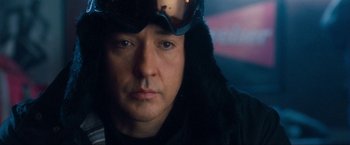 Movie still from “War, Inc.” (2008), directed by Joshua Seftel – A person wearing goggles and a jacket; Close Up shot, Over the shoulder angle