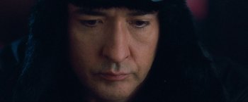 Movie still from “War, Inc.” (2008), directed by Joshua Seftel – A man's face with a hat on his head; Extreme Close Up shot, Low angle