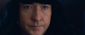 Movie still from “War, Inc.” (2008), directed by Joshua Seftel – A man's face with a hood over his head; Extreme Close Up shot, Low angle